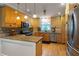 Well-equipped kitchen with stainless steel appliances, natural wood cabinets, and granite countertops at 2050 Lyda Ln, Loganville, GA 30052