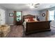 Comfortable main bedroom with a king bed, soft carpet, and natural light from windows at 2050 Lyda Ln, Loganville, GA 30052