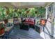 Inviting screened porch with comfortable seating and decorative hanging plants, nestled in the trees at 2050 Lyda Ln, Loganville, GA 30052