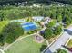 Aerial view showcasing community amenities: pool, tennis courts, playground amid lush greenery at 3533 Aberdeen Way, Douglasville, GA 30135