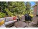 Outdoor seating in a cozy backyard, complete with a grill and lush greenery at 3533 Aberdeen Way, Douglasville, GA 30135