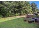 Lush green backyard featuring a patio with outdoor seating and a verdant lawn at 3533 Aberdeen Way, Douglasville, GA 30135