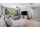 Bright bonus room with a large sectional couch, ceiling fan, and a view of the backyard at 3533 Aberdeen Way, Douglasville, GA 30135