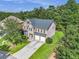 Aerial view of a two-story home with a stone and siding facade, a two-car garage, and a green lawn at 3533 Aberdeen Way, Douglasville, GA 30135