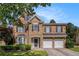 Charming two-story home with brick and stone facade, manicured lawn, and two-car garage at 3533 Aberdeen Way, Douglasville, GA 30135