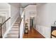 Inviting foyer featuring hardwood floors, a staircase with carpeted steps, and stylish decor at 3533 Aberdeen Way, Douglasville, GA 30135