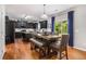 Spacious kitchen with dark cabinetry, stainless steel appliances, and an adjacent dining area with backyard access at 3533 Aberdeen Way, Douglasville, GA 30135