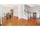 Open-concept living area with hardwood floors, staircase, and adjacent dining room with decorative molding at 3533 Aberdeen Way, Douglasville, GA 30135