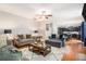 Open-concept living room with hardwood floors, comfortable seating, and access to the kitchen at 3533 Aberdeen Way, Douglasville, GA 30135