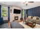 Cozy living room featuring a fireplace, a large television, and comfortable seating, perfect for relaxation at 3533 Aberdeen Way, Douglasville, GA 30135