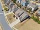 An aerial view of a suburban neighborhood showcasing well-maintained homes, manicured lawns, and tree-lined streets at 441 Spring View Dr, Woodstock, GA 30188