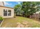 A view of the backyard which shows the homes well-manicured lawn, fence, landscaping, and the patio at 441 Spring View Dr, Woodstock, GA 30188