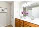 Bathroom with double vanity, tile floor, and framed print at 441 Spring View Dr, Woodstock, GA 30188