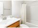 Well-lit bathroom with a single sink vanity and a shower-tub combination with a patterned curtain at 441 Spring View Dr, Woodstock, GA 30188