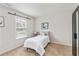 Minimalist bedroom with neutral tones, a comfortable bed, and a black wardrobe for storage solutions at 441 Spring View Dr, Woodstock, GA 30188