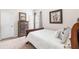 Cozy bedroom with a comfortable bed, wood dresser and pleasant natural light from an adjacent window at 441 Spring View Dr, Woodstock, GA 30188