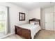 Serene bedroom featuring a comfortable bed, soft neutral walls and pleasant natural light from a window at 441 Spring View Dr, Woodstock, GA 30188