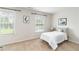Bright bedroom featuring large windows, neutral tones, and minimalist decor for a calming retreat at 441 Spring View Dr, Woodstock, GA 30188