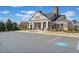 Exterior of a community clubhouse with stone accents, large windows, and accessible parking on a sunny day at 441 Spring View Dr, Woodstock, GA 30188