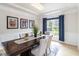 Formal dining room featuring an elegant light fixture, large window, and wainscoting at 441 Spring View Dr, Woodstock, GA 30188