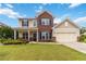 Charming two-story home featuring a well-manicured lawn and inviting curb appeal at 441 Spring View Dr, Woodstock, GA 30188