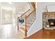 Inviting foyer featuring a staircase with stone fireplace and beautiful hardwood floors at 441 Spring View Dr, Woodstock, GA 30188