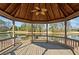 Interior view of a wooden gazebo overlooking a scenic pond, providing a shaded area for relaxation and enjoyment at 441 Spring View Dr, Woodstock, GA 30188