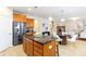 Open concept kitchen with granite counters, wood island, and view of the living area at 441 Spring View Dr, Woodstock, GA 30188