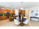 Open kitchen featuring wood cabinets, black countertops, island and a breakfast table with seating at 441 Spring View Dr, Woodstock, GA 30188