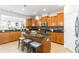 Bright kitchen featuring wood cabinets, granite countertops, and a center island with bar stools at 441 Spring View Dr, Woodstock, GA 30188