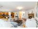 Open-concept living room with hardwood floors, ample seating, and kitchen access at 441 Spring View Dr, Woodstock, GA 30188