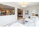 Open-concept living area featuring a white sofa and views into the kitchen and fireplace through interior openings at 441 Spring View Dr, Woodstock, GA 30188