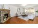 Bright living room boasts hardwood floors, stone fireplace, and comfortable seating at 441 Spring View Dr, Woodstock, GA 30188