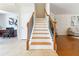 Elegant staircase with wood and wrought iron details connects multiple floors of the home at 441 Spring View Dr, Woodstock, GA 30188