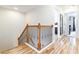 Elegant staircase with wood and black iron railing, leading to the upper level with hardwood flooring at 441 Spring View Dr, Woodstock, GA 30188