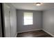 Bedroom with neutral walls, wood-look flooring, and a bright window at 70 Ruzelle Se Dr, Atlanta, GA 30354