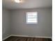 Bedroom with hardwood floors, one window, neutral gray walls and blinds at 70 Ruzelle Se Dr, Atlanta, GA 30354