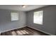 Bedroom with hardwood floors, two windows, neutral gray walls and blinds at 70 Ruzelle Se Dr, Atlanta, GA 30354