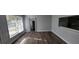 Dining room featuring hardwood floors, natural light, and a pass-through to the kitchen at 70 Ruzelle Se Dr, Atlanta, GA 30354
