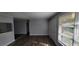 Bright living room with hardwood floors and neutral paint; door leads to exterior, pass through to kitchen at 70 Ruzelle Se Dr, Atlanta, GA 30354