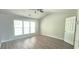 Bedroom features a vaulted ceiling, ceiling fan, light wood flooring, and large windows at 2061 Fosco Dr, Duluth, GA 30097