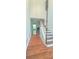 Elegant foyer featuring hardwood floors, wainscoting, and a staircase leading to the upper level of the home at 2061 Fosco Dr, Duluth, GA 30097