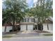 Charming townhome exterior with brick and siding, complemented by a two-car garage and a well-manicured lawn at 2061 Fosco Dr, Duluth, GA 30097
