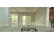 Stylish kitchen with granite countertops, a stainless steel sink, and a view of the backyard through a sliding glass door at 2061 Fosco Dr, Duluth, GA 30097