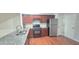 Modern kitchen boasts granite counters, stainless steel appliances, ample storage, and hardwood floors at 2061 Fosco Dr, Duluth, GA 30097
