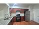 Well-appointed kitchen featuring granite countertops, stainless steel appliances, and ample cabinet space at 2061 Fosco Dr, Duluth, GA 30097