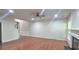Open-concept living area featuring hardwood floors, a fireplace, and seamless access to other areas of the home at 2061 Fosco Dr, Duluth, GA 30097