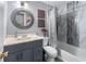 Bathroom features modern vanity with round mirror, tiled shower and tub, and neutral walls at 3778 Berdon Ln, Decatur, GA 30034