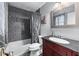Bathroom features a vanity with a cherry wood cabinet, a tiled shower and tub at 3778 Berdon Ln, Decatur, GA 30034