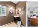 Functional bathroom featuring a vanity sink, ample lighting, and a view into a bright, airy office space at 3778 Berdon Ln, Decatur, GA 30034